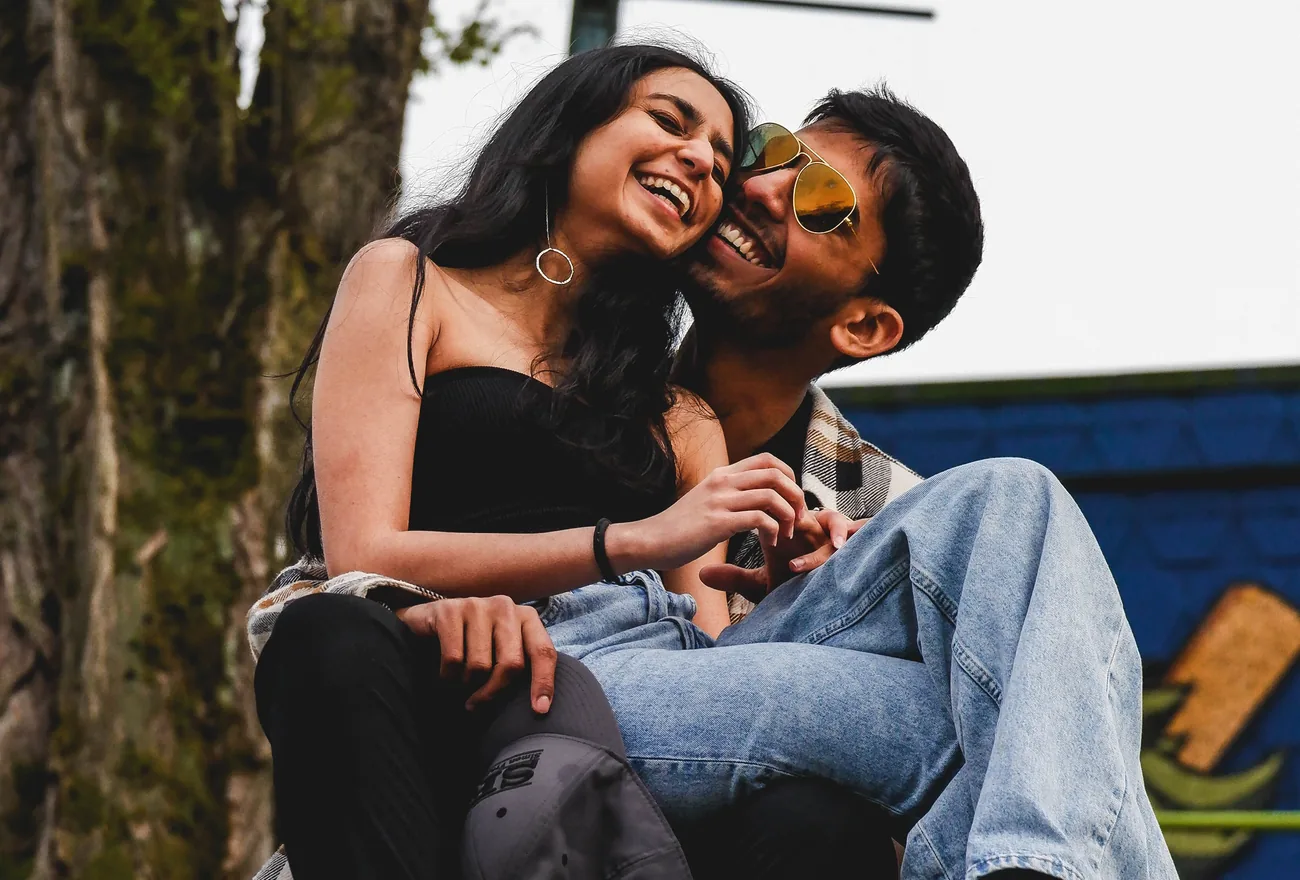An Indian couple laughing together outdoors
